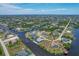 Waterfront property showcasing a canal-front home with a backyard at 9222 Melody Cir, Port Charlotte, FL 33981