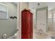 Bathroom with toilet and red cabinet at 9222 Melody Cir, Port Charlotte, FL 33981