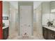 Spa-like bathroom with double vanities, a large shower, and mosaic tile floors at 9222 Melody Cir, Port Charlotte, FL 33981