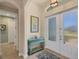 Bright entryway with double doors and a charming console table at 9222 Melody Cir, Port Charlotte, FL 33981