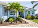 Landscaped front yard with palm trees and a brick pathway to the entryway at 9222 Melody Cir, Port Charlotte, FL 33981