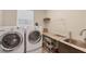 Laundry room with washer, dryer, and granite countertop at 9222 Melody Cir, Port Charlotte, FL 33981