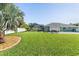 Large backyard with a screened-in pool and patio area at 126 Spur Dr, Rotonda West, FL 33947