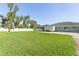 Large grassy backyard with a screened-in patio and a storage shed at 126 Spur Dr, Rotonda West, FL 33947