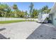 Large backyard with gravel area and privacy fence at 126 Spur Dr, Rotonda West, FL 33947