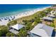 Aerial view of a beach with people, umbrellas, and beach pavilions at 126 Spur Dr, Rotonda West, FL 33947