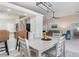 Dining area with light gray table and chairs, open to kitchen at 126 Spur Dr, Rotonda West, FL 33947