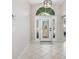 Bright entryway with tile flooring and a decorative front door at 126 Spur Dr, Rotonda West, FL 33947