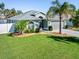 Single-story house with a green exterior, landscaping, and palm trees at 126 Spur Dr, Rotonda West, FL 33947