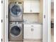 Laundry room with stackable washer and dryer, and cabinets at 126 Spur Dr, Rotonda West, FL 33947