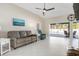 Living room with gray sofa, blue recliner, and view of the pool at 126 Spur Dr, Rotonda West, FL 33947