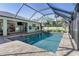 Screened-in pool with view of the backyard and house at 126 Spur Dr, Rotonda West, FL 33947