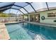 Inviting swimming pool with screened enclosure and spacious patio at 126 Spur Dr, Rotonda West, FL 33947