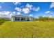 Large backyard with grassy lawn and screened patio at 14252 Joggins Ave, Port Charlotte, FL 33981