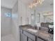 Modern bathroom with granite countertop, gray cabinets, and walk-in shower at 14252 Joggins Ave, Port Charlotte, FL 33981