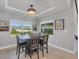 Bright dining area with a square table and six chairs, overlooking the backyard at 14252 Joggins Ave, Port Charlotte, FL 33981