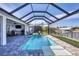 Enjoy this relaxing pool and patio area with screened enclosure at 15448 Melport Cir, Port Charlotte, FL 33981