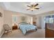 Comfortable bedroom with a ceiling fan and sliding door access to patio at 15546 Viscount Cir, Port Charlotte, FL 33981