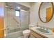 Clean bathroom with a shower/tub combo and an oval mirror at 1951 Greenlawn Dr, Englewood, FL 34223