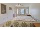 Main bedroom with a double bed and large window at 1951 Greenlawn Dr, Englewood, FL 34223