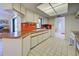 Efficient kitchen with white cabinets and orange tile at 1951 Greenlawn Dr, Englewood, FL 34223