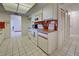 Efficient kitchen with white cabinets and orange tile at 1951 Greenlawn Dr, Englewood, FL 34223