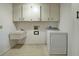 Laundry room with washer, dryer, and utility sink at 1951 Greenlawn Dr, Englewood, FL 34223