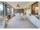 Screened porch with table and chairs, view of backyard at 1951 Greenlawn Dr, Englewood, FL 34223