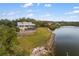 Waterfront home with private pool and expansive lot, aerial view at 1990-B Bayshore Dr, Englewood, FL 34223