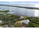 Aerial view of a waterfront home with a large lot and private dock at 1990-B Bayshore Dr, Englewood, FL 34223