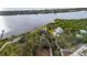 Aerial view showcasing waterfront property and lush landscaping at 1990-B Bayshore Dr, Englewood, FL 34223