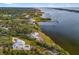 An aerial view of a home on the waterfront with a large lot at 1990-B Bayshore Dr, Englewood, FL 34223