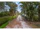 Long private driveway leading to a waterfront home at 1990-B Bayshore Dr, Englewood, FL 34223