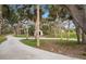 Long private driveway leading to the house, lined with trees at 1990-B Bayshore Dr, Englewood, FL 34223