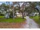 Charming waterfront home with a long driveway and mature trees at 1990-B Bayshore Dr, Englewood, FL 34223