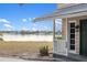 Charming front porch with water views and white railing at 1990-B Bayshore Dr, Englewood, FL 34223