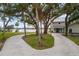 House with circular driveway, mature trees, and waterfront views at 1990-B Bayshore Dr, Englewood, FL 34223