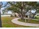 Two-story house with long driveway, lush landscaping, and waterfront access at 1990-B Bayshore Dr, Englewood, FL 34223