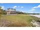 House exterior view showcasing waterfront location and landscaping at 1990-B Bayshore Dr, Englewood, FL 34223