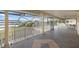 Spacious screened porch overlooks the water, featuring tile flooring and a hammock at 1990-B Bayshore Dr, Englewood, FL 34223