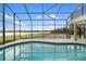 Relaxing kidney-shaped pool with a screened enclosure and water view at 1990-B Bayshore Dr, Englewood, FL 34223