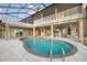 Freeform swimming pool with stone accents and screened enclosure at 1990-B Bayshore Dr, Englewood, FL 34223