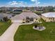 Aerial view of a single-story house with a large front yard and driveway at 233 Marker Rd, Rotonda West, FL 33947