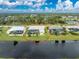 Aerial view of a single story house next to a canal at 233 Marker Rd, Rotonda West, FL 33947