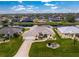 Aerial view of a single-Gathering home with a canal-front lot and lush landscaping at 233 Marker Rd, Rotonda West, FL 33947