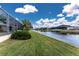 Peaceful backyard scene with canal views and lush greenery at 233 Marker Rd, Rotonda West, FL 33947