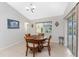 Bright dining room with wood table and chairs, adjacent to the kitchen at 233 Marker Rd, Rotonda West, FL 33947