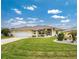 Single-story house with yellow exterior, landscaping and a two-car garage at 233 Marker Rd, Rotonda West, FL 33947