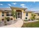 Welcoming front entrance with landscaped walkway and screened porch at 233 Marker Rd, Rotonda West, FL 33947