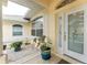 Covered front porch entry with decorative glass door and potted plants at 233 Marker Rd, Rotonda West, FL 33947